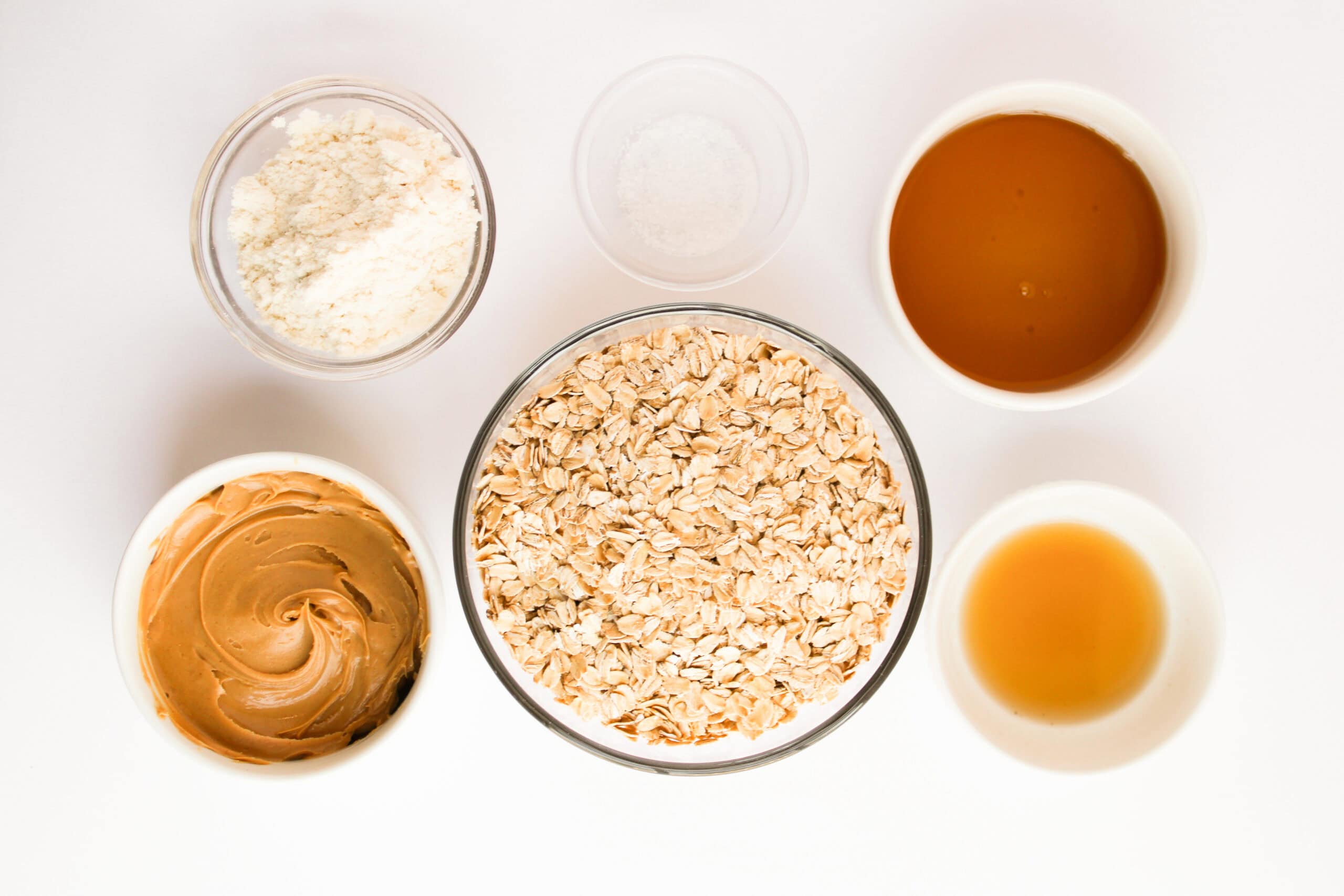 Rolled oats, protein powder, peanut butter, honey, vanilla extract, and salt.