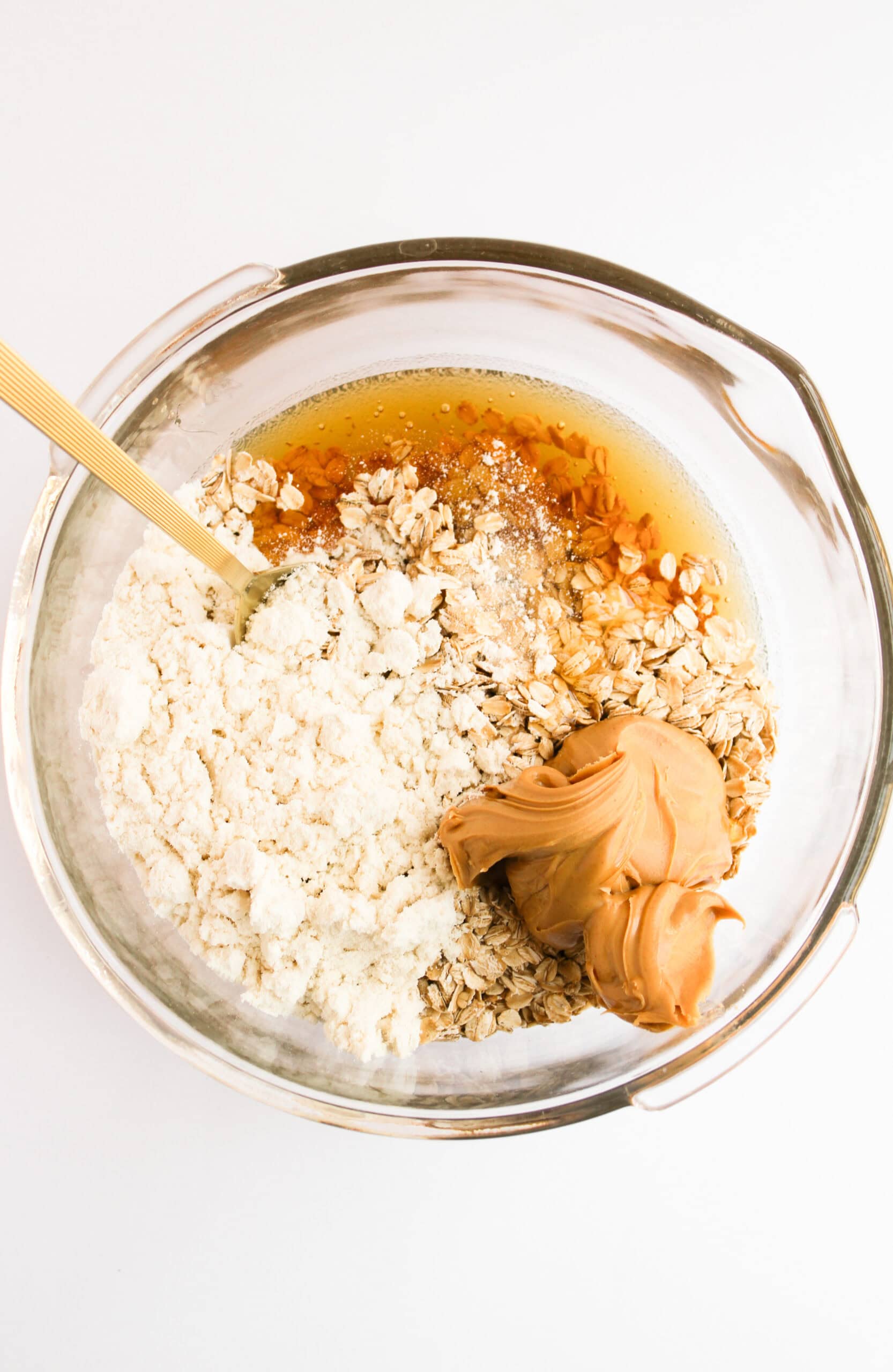 Rolled oats, protein powder, peanut butter, honey, vanilla, and salt in a mixing bowl.