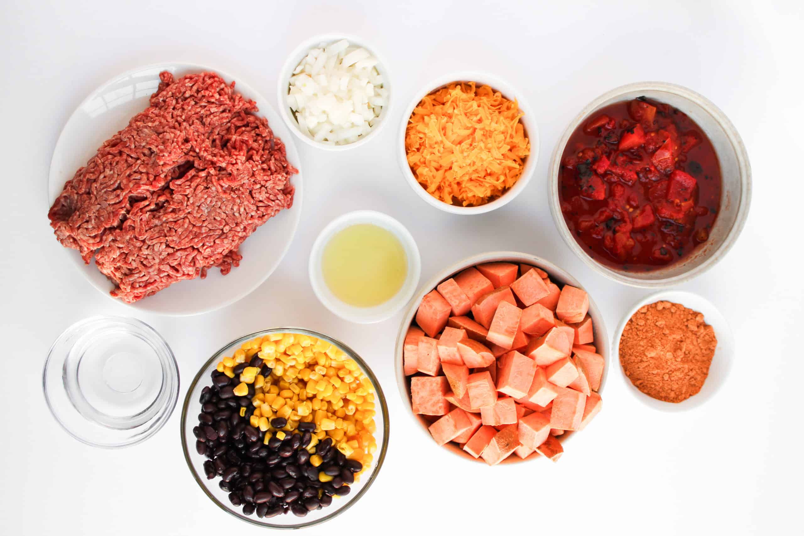 Ground beef, sweet potatoes, corn, black beans, fire-roasted tomatoes, onion, cheese, oil, water, and taco seasoning.