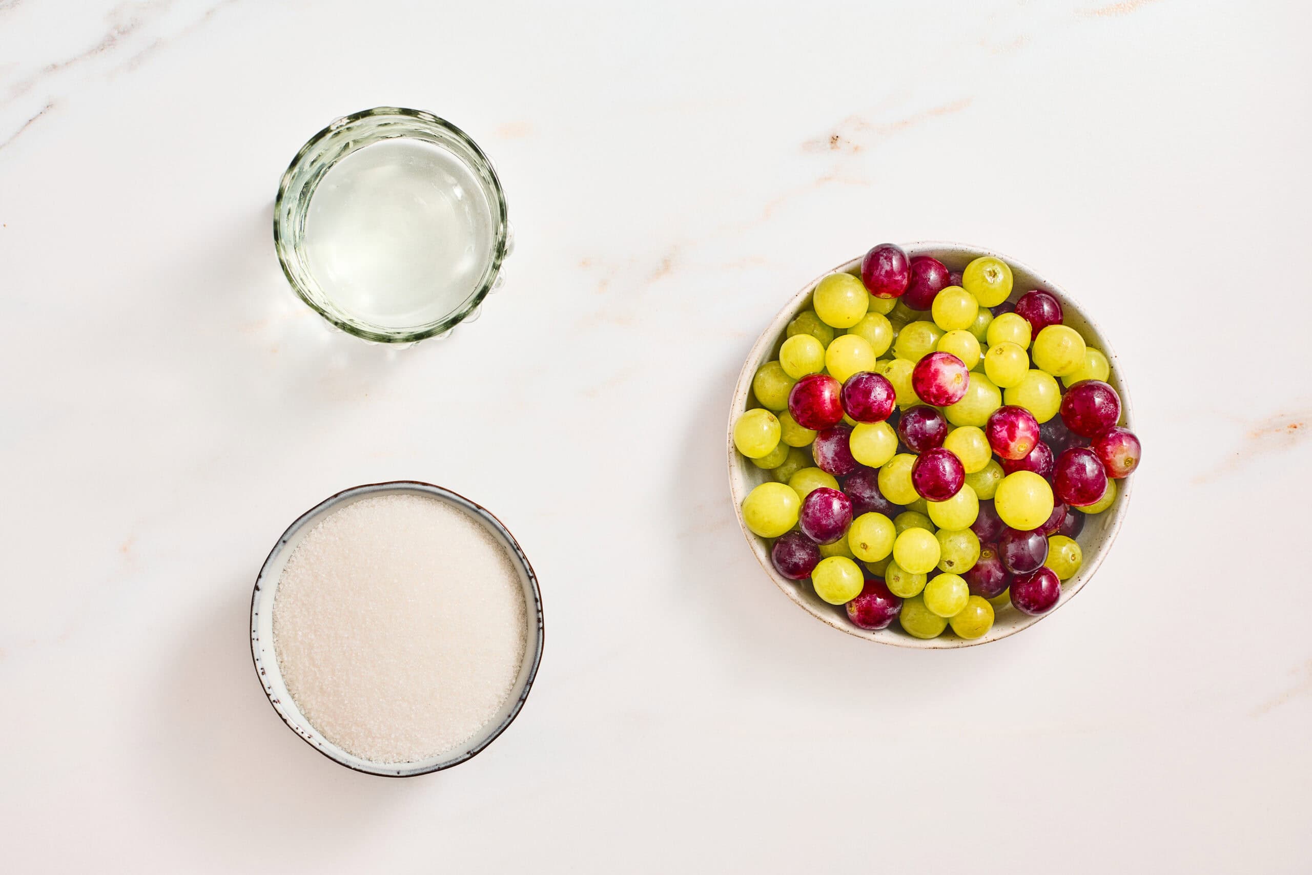 Red and green grapes, water, and sugar for sugar coated grapes.