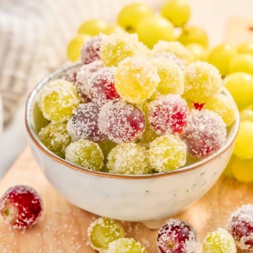 A bowl of sparkling sugar coated red and green grapes.
