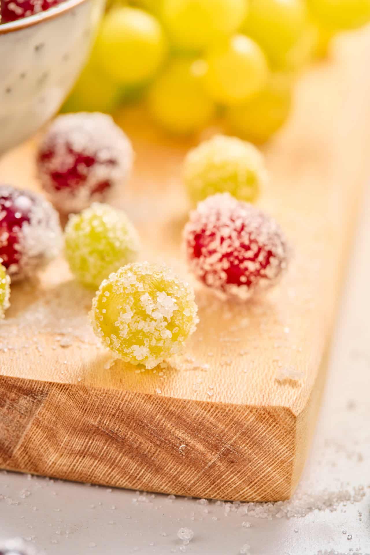 Close-up of red and green grapes with a crisp sparkling sugar coating.