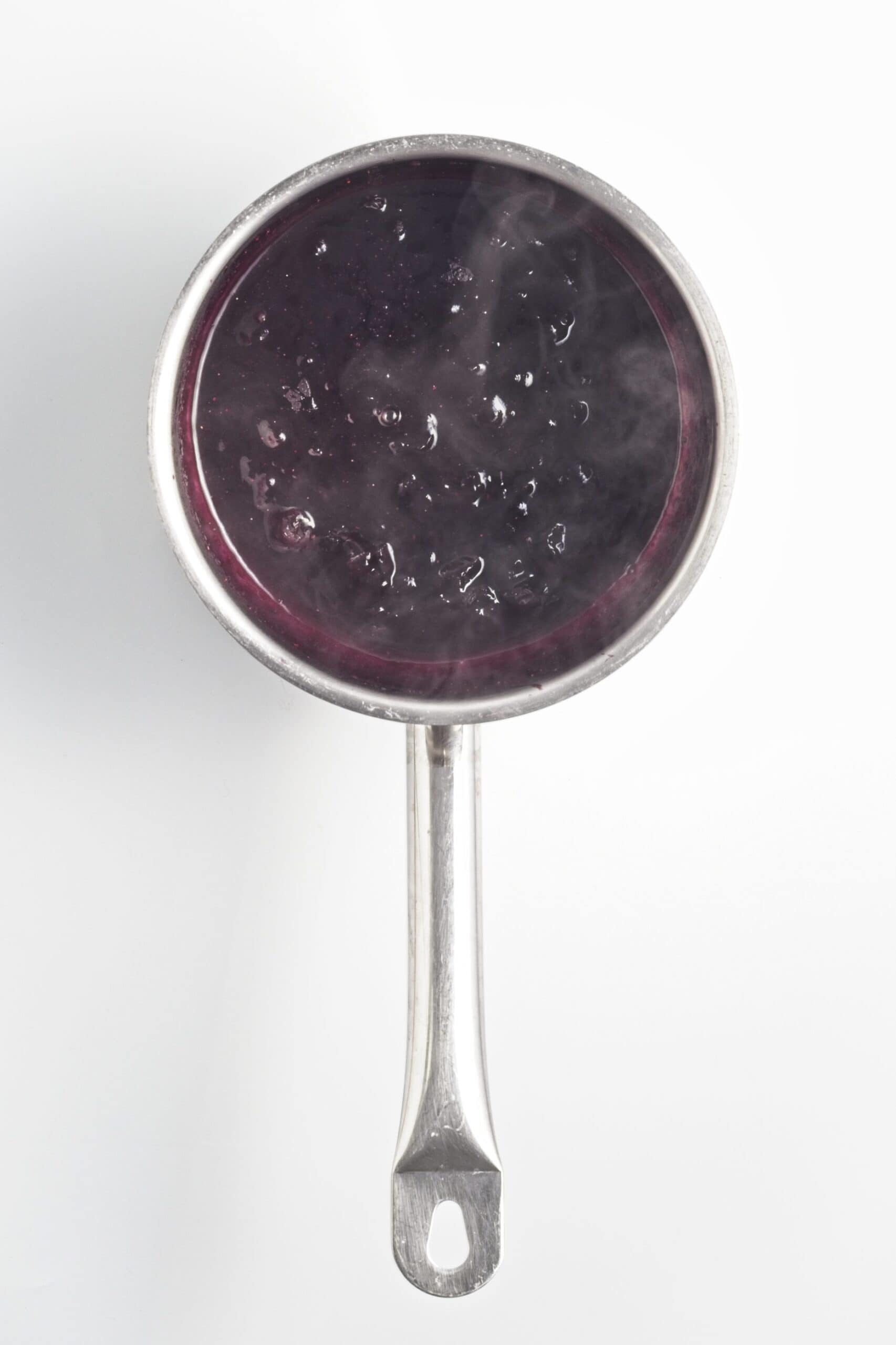 Cooked blueberry compote thickened in a saucepan.