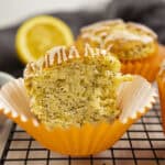 Greek yogurt lemon poppy seed muffin with lemon glaze showing its tender crumb.