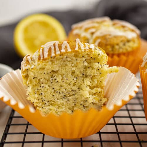 Greek yogurt lemon poppy seed muffin with lemon glaze showing its tender crumb.