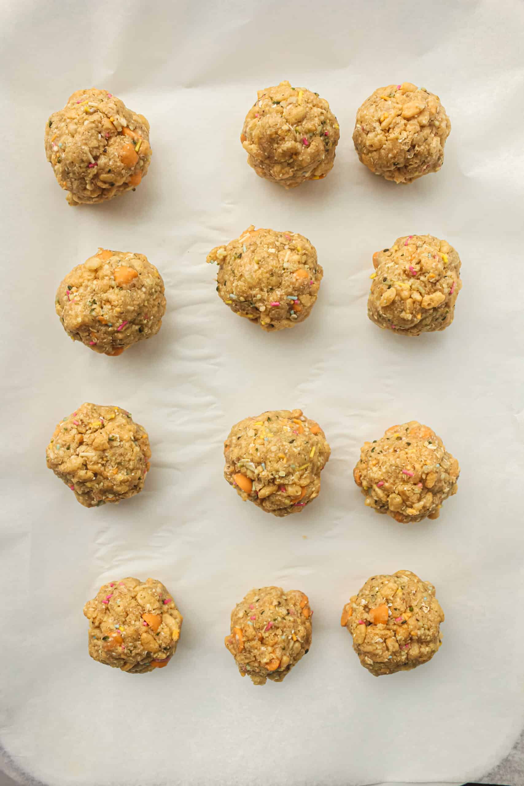 Rolled after school energy balls arranged on parchment paper before chilling.