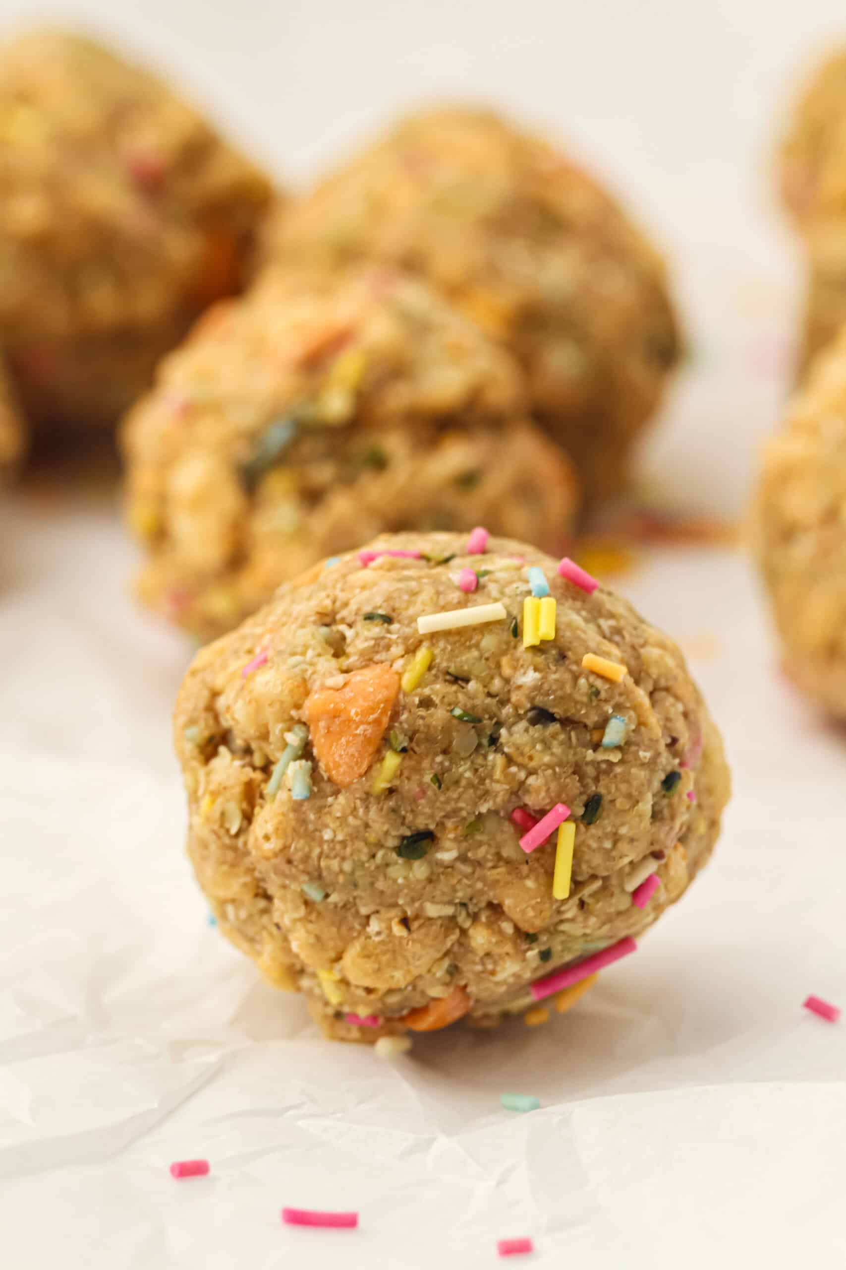 Close-up of an after school energy ball with butterscotch chips, hemp seeds, and colorful sprinkles.