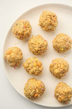 After school energy balls with butterscotch chips and colorful sprinkles arranged on a plate.