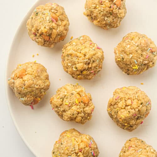 After school energy balls with butterscotch chips and colorful sprinkles arranged on a plate.