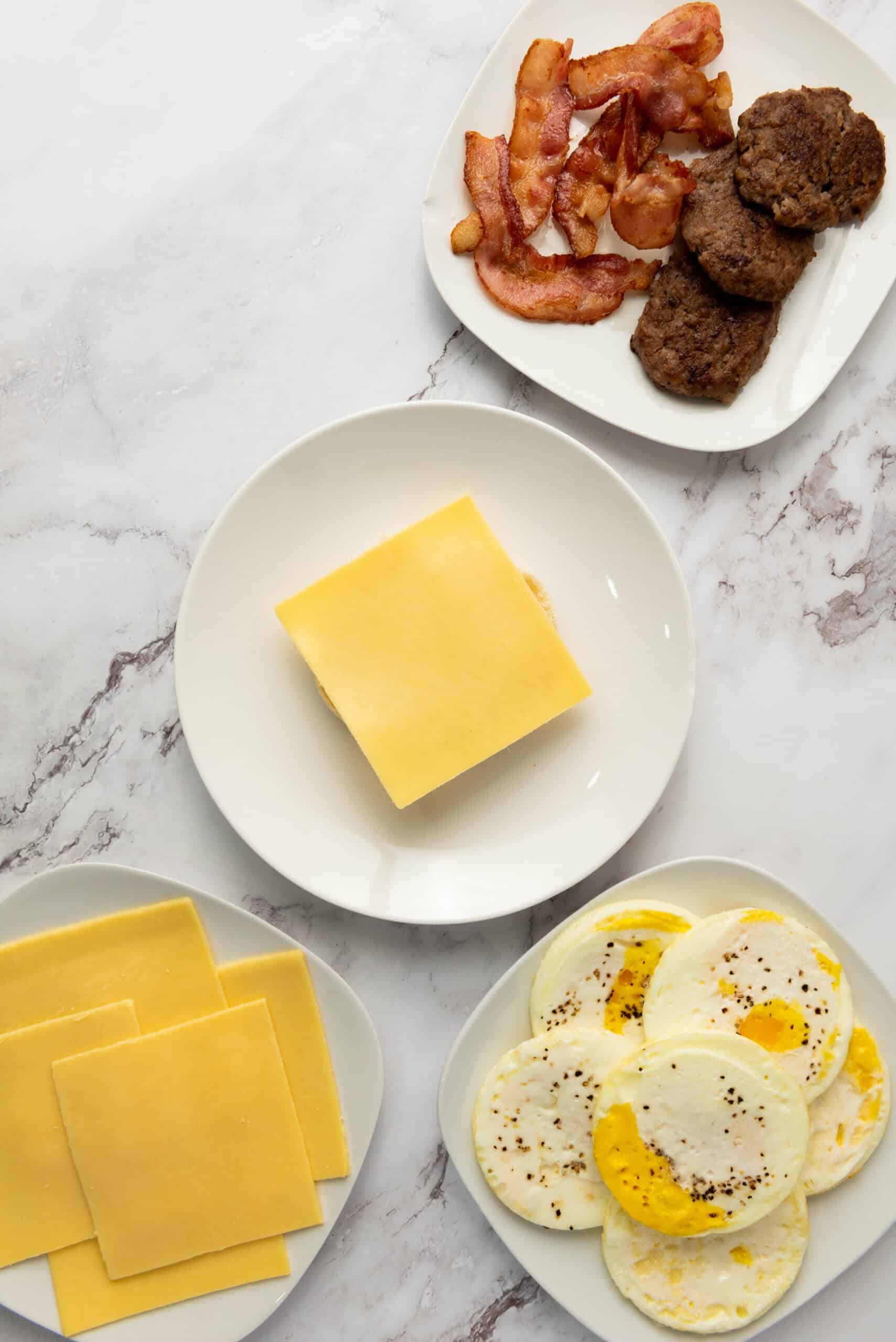A slice of cheese placed on an English muffin bottom.