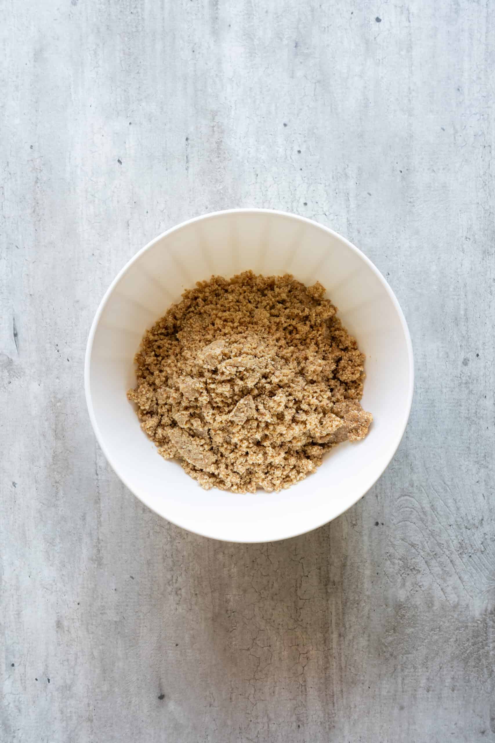 Sticky oat, cashew, date, and almond butter dough in a mixing bowl.