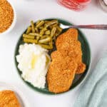 Homemade Shake and Bake pork chops served with mashed potatoes and green beans.