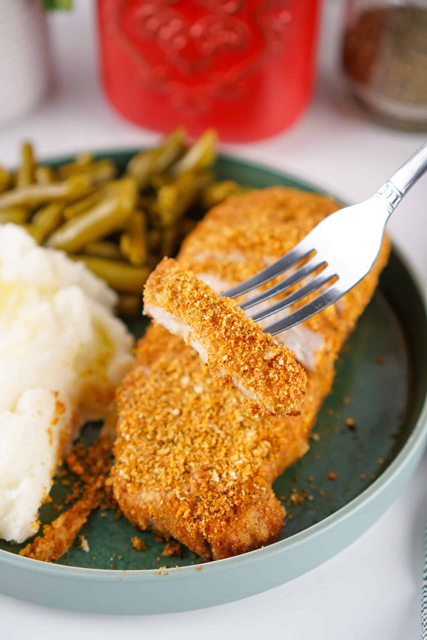 Close-up of a sliced pork chop with a crispy homemade Shake and Bake coating.