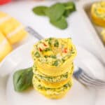 A stack of cottage cheese egg bites with spinach, bell pepper, and onion.