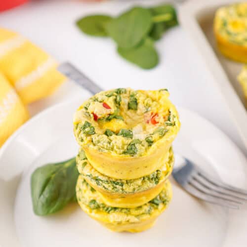 A stack of cottage cheese egg bites with spinach, bell pepper, and onion.