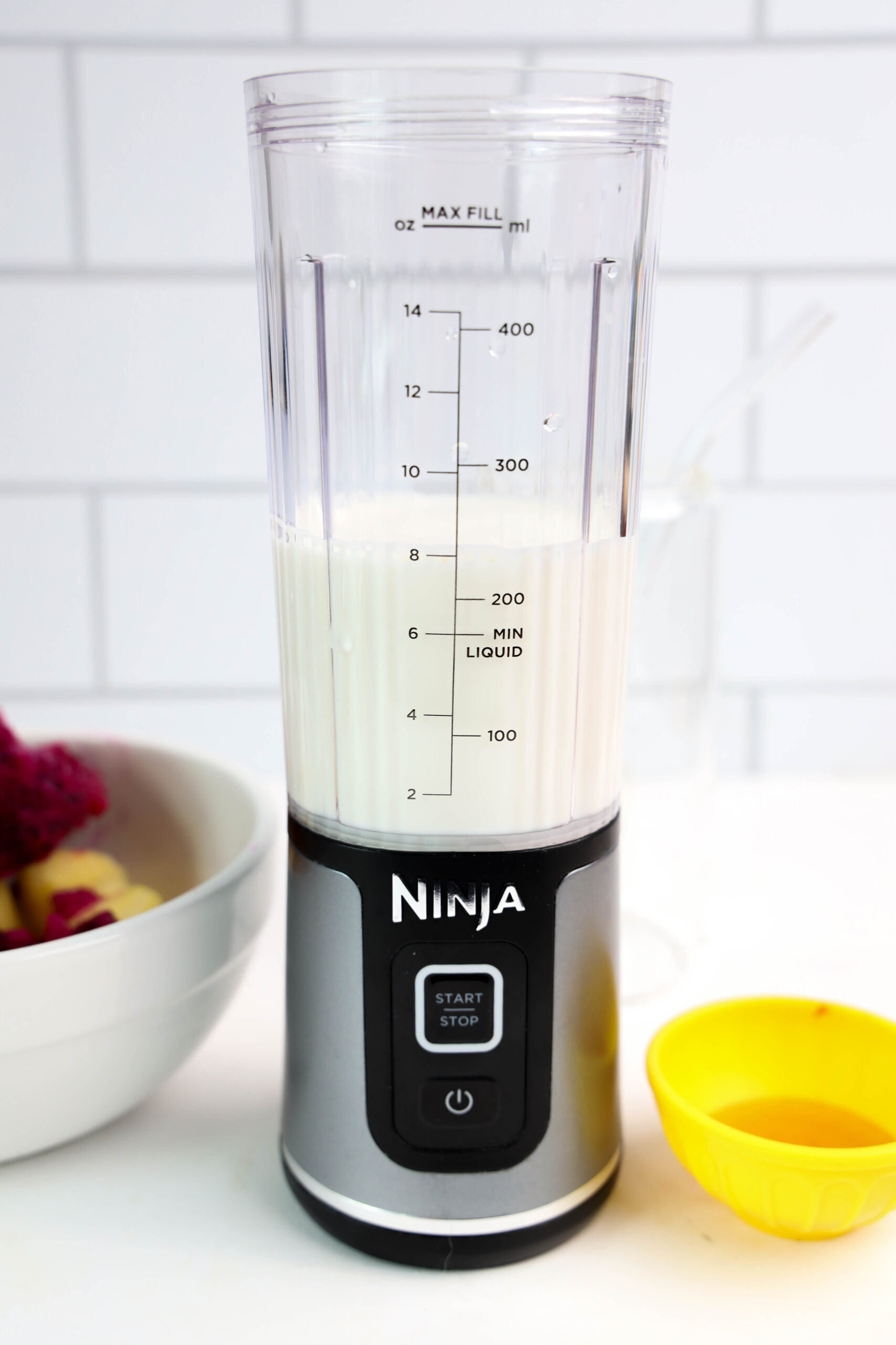 Milk in a personal blender before adding frozen fruit.