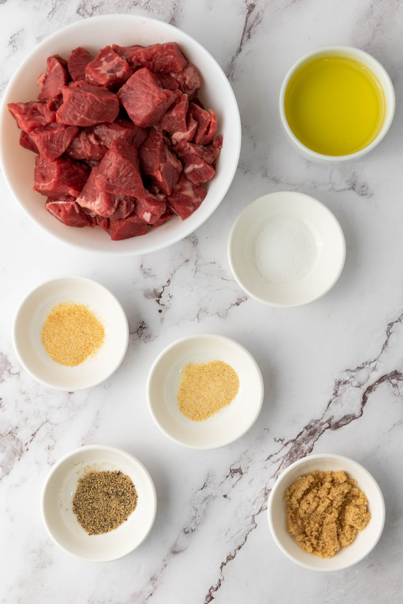 Cubed sirloin, olive oil, salt, pepper, garlic powder, onion powder, and brown sugar.