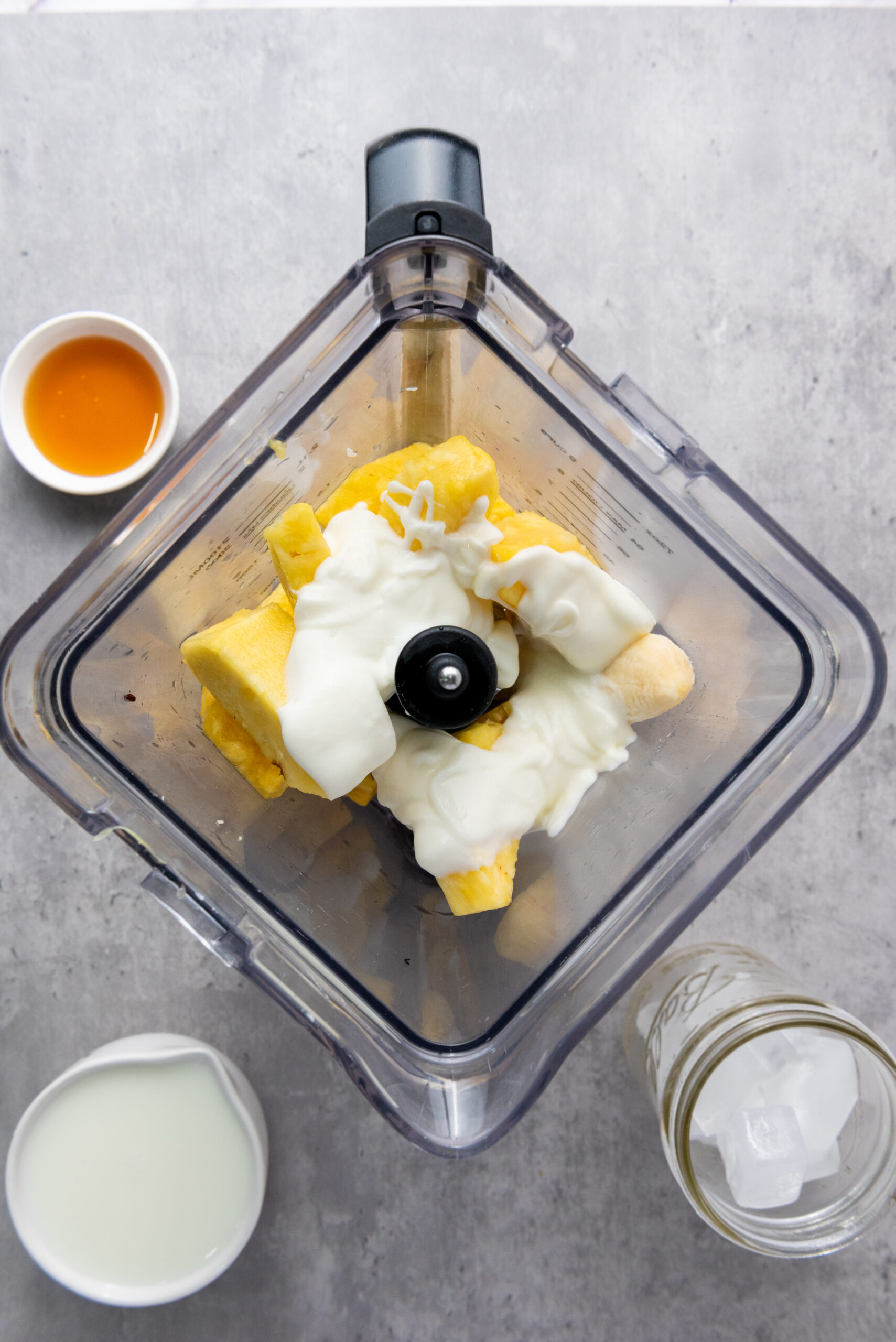 Pineapple, banana, and Greek yogurt in a blender.