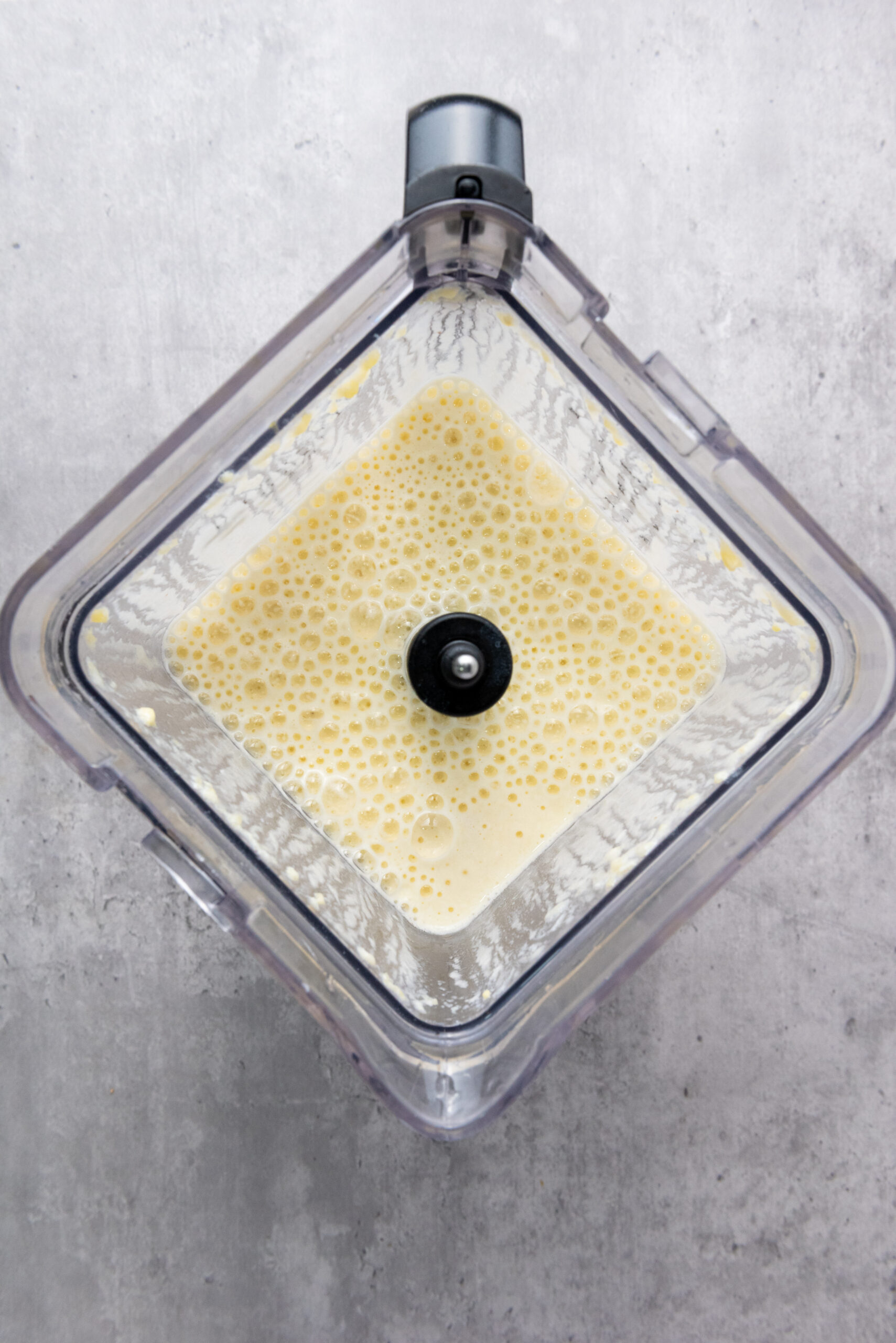 Smooth and creamy pineapple banana smoothie in a blender.