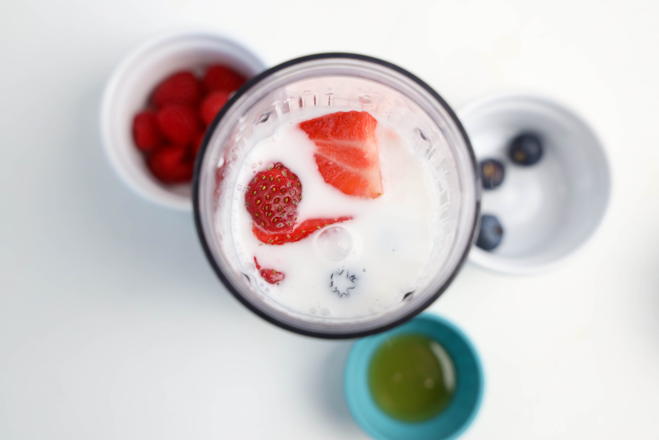 The remaining sliced strawberries added to the personal blender.