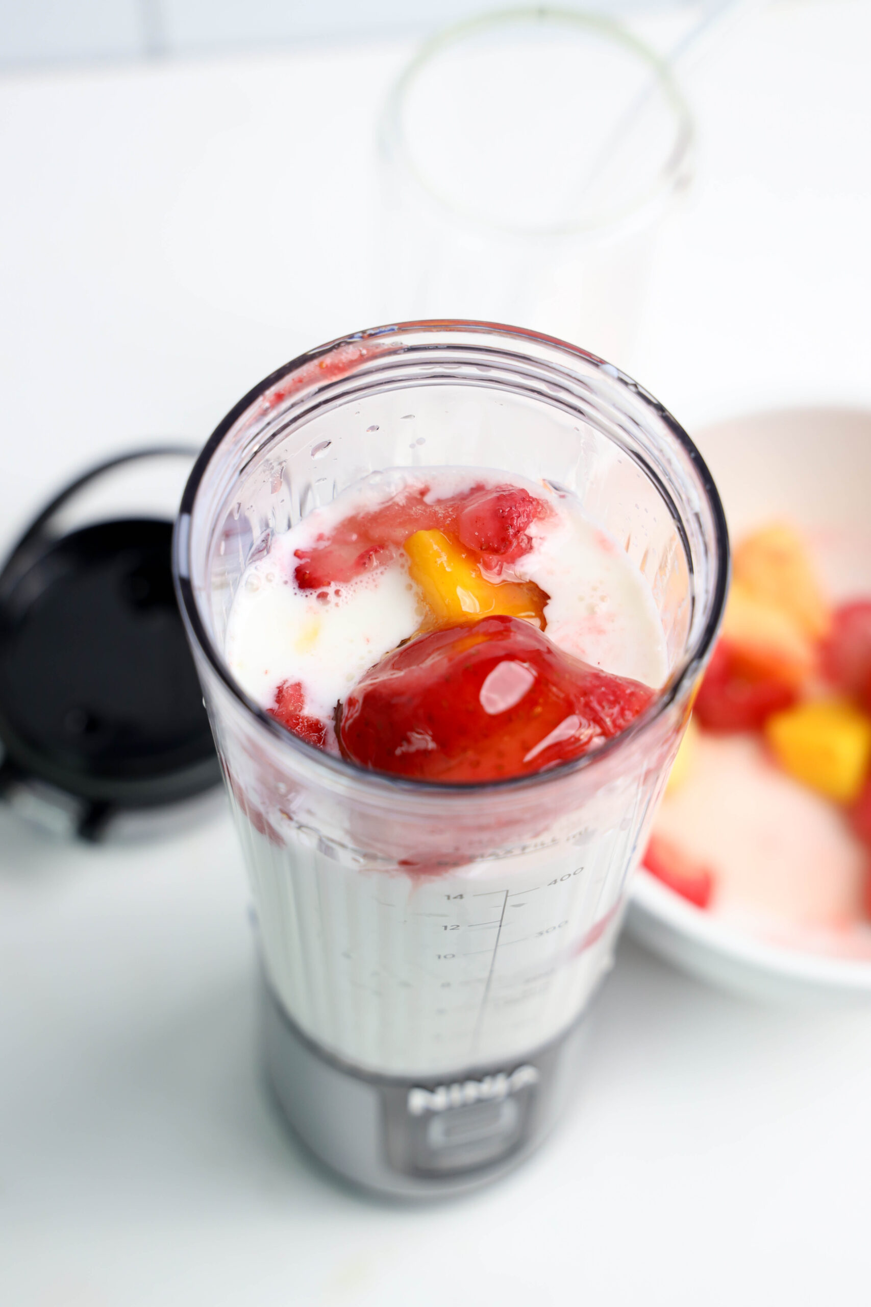 Honey drizzled over frozen tropical fruit and milk in a personal blender.