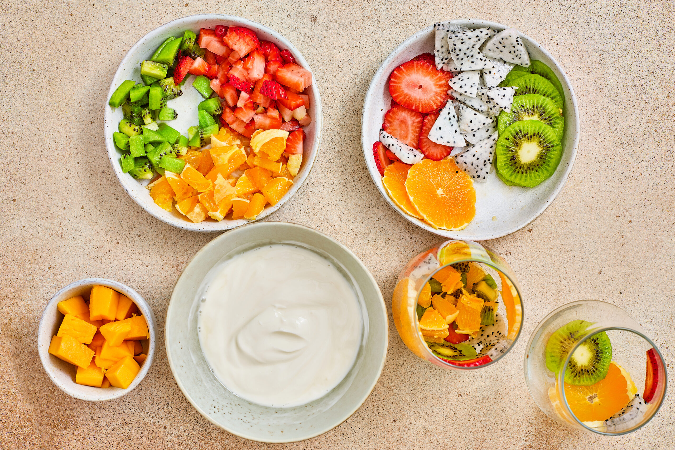 Mango, strawberry, orange, and kiwi layered in a serving glass.