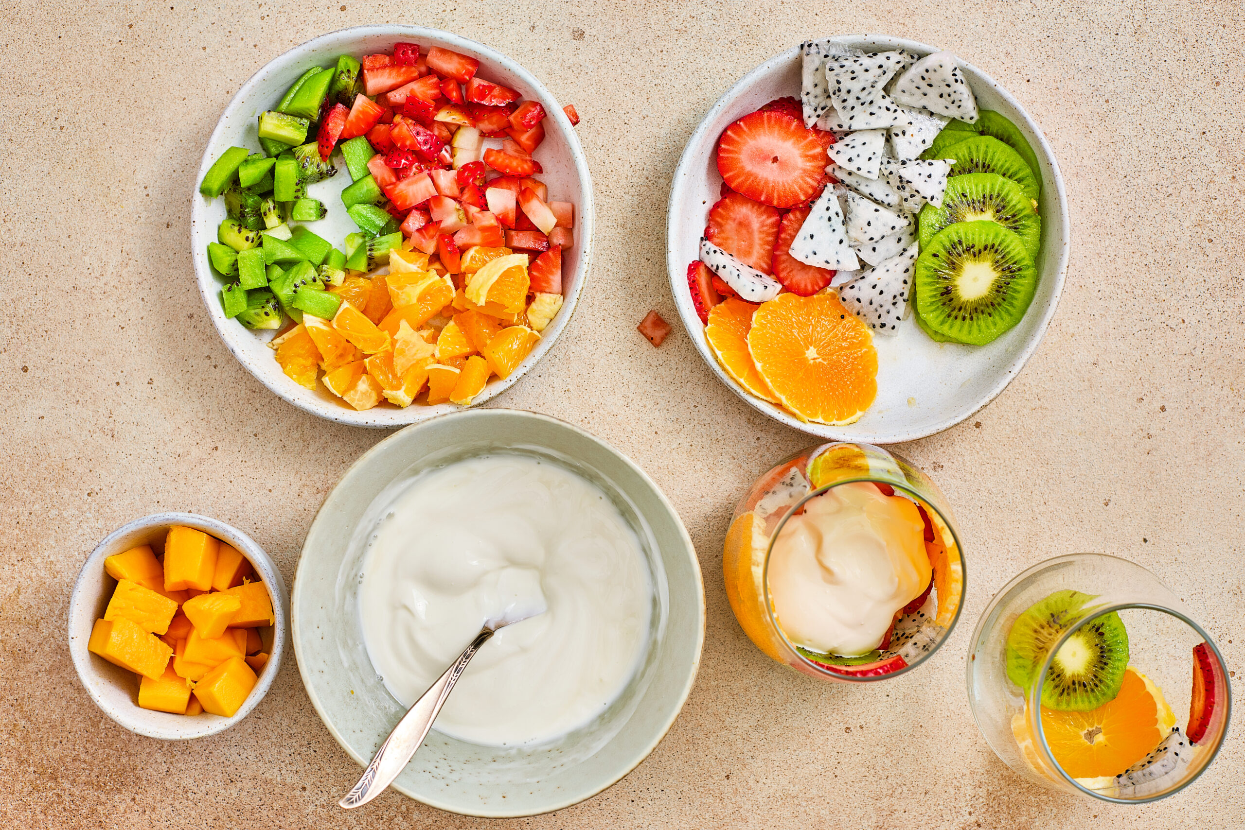 Sweetened Greek yogurt spooned over the fruit layer.