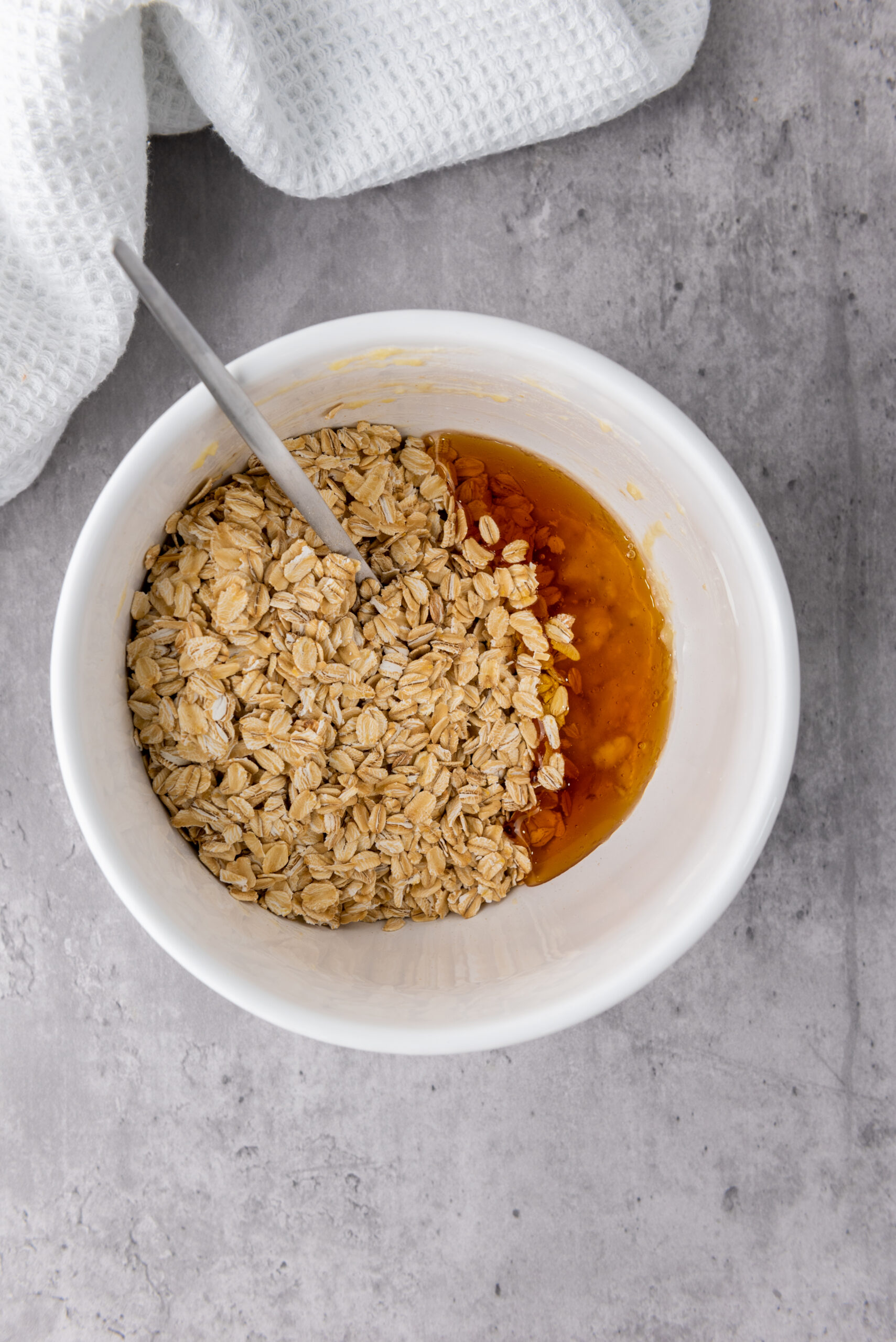 Rolled oats and honey added to mashed banana for three-ingredient granola cups.
