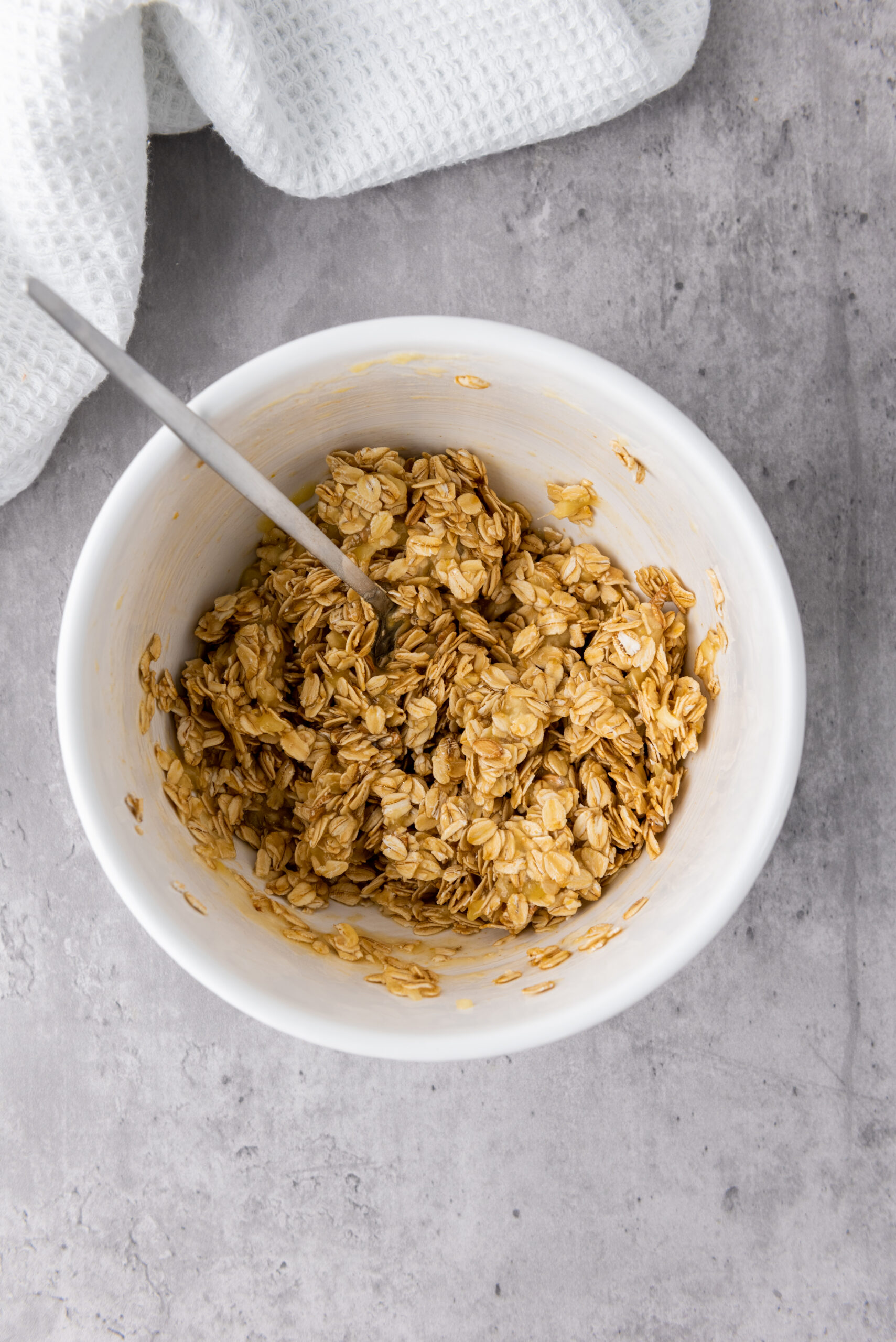 Banana, rolled oats, and honey mixed together for granola cups.