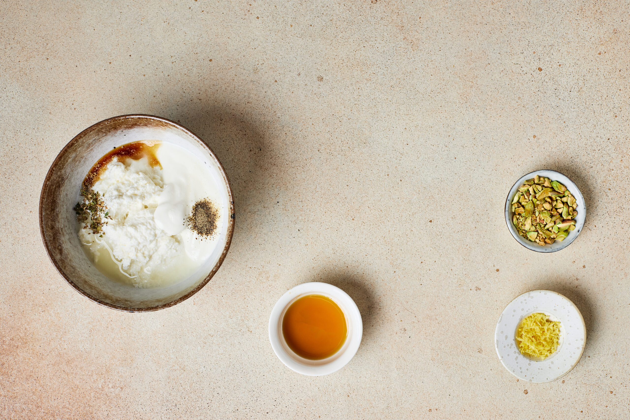 Ricotta, Greek yogurt, honey, thyme, salt, and pepper ready to whisk together.