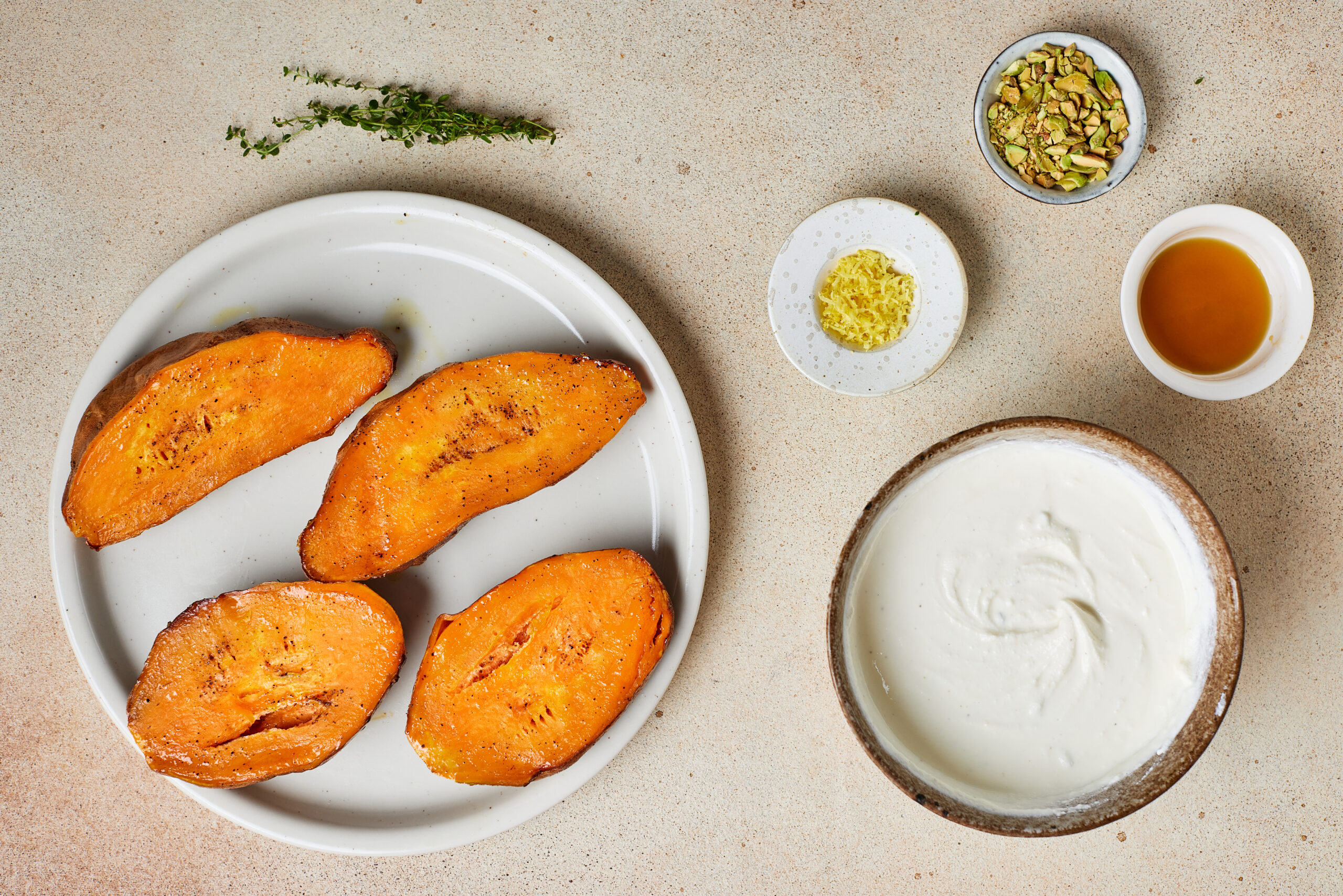 Tender caramelized sweet potato halves beside a bowl of smooth whipped ricotta.