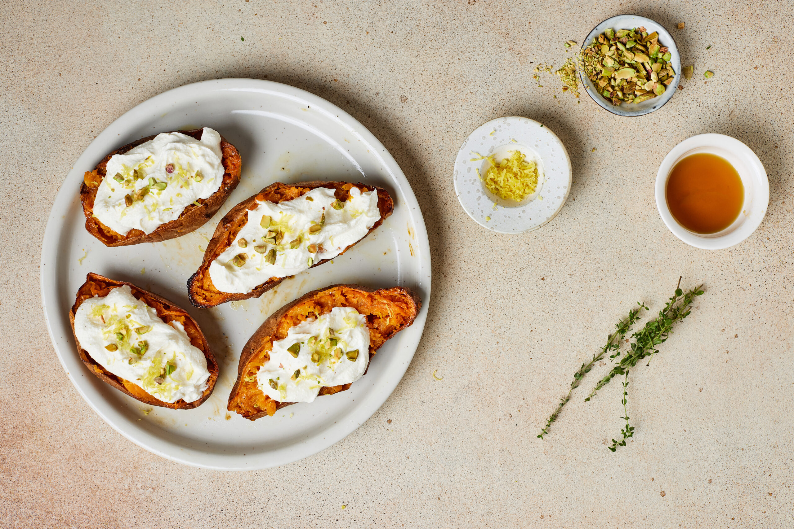 Sweet potato halves topped with whipped ricotta, chopped pistachios, and lemon zest.