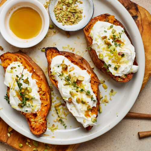 Roasted sweet potato halves topped with whipped ricotta, pistachios, lemon zest, thyme, and honey.