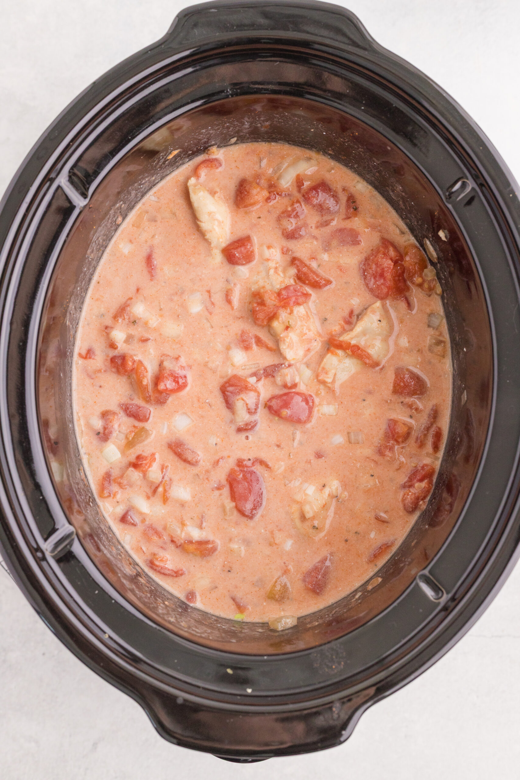 Sour cream stirred into chicken paprikash until the sauce is creamy.