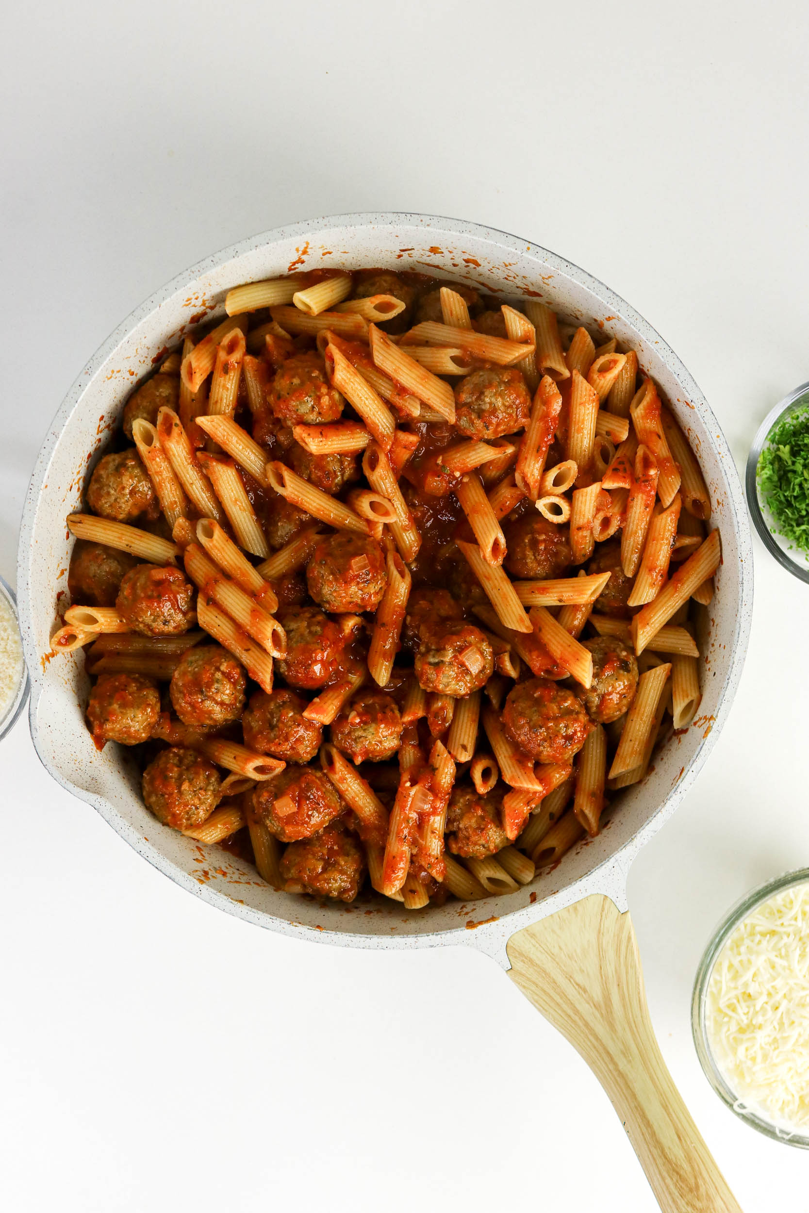 Penne and meatballs evenly coated in marinara sauce