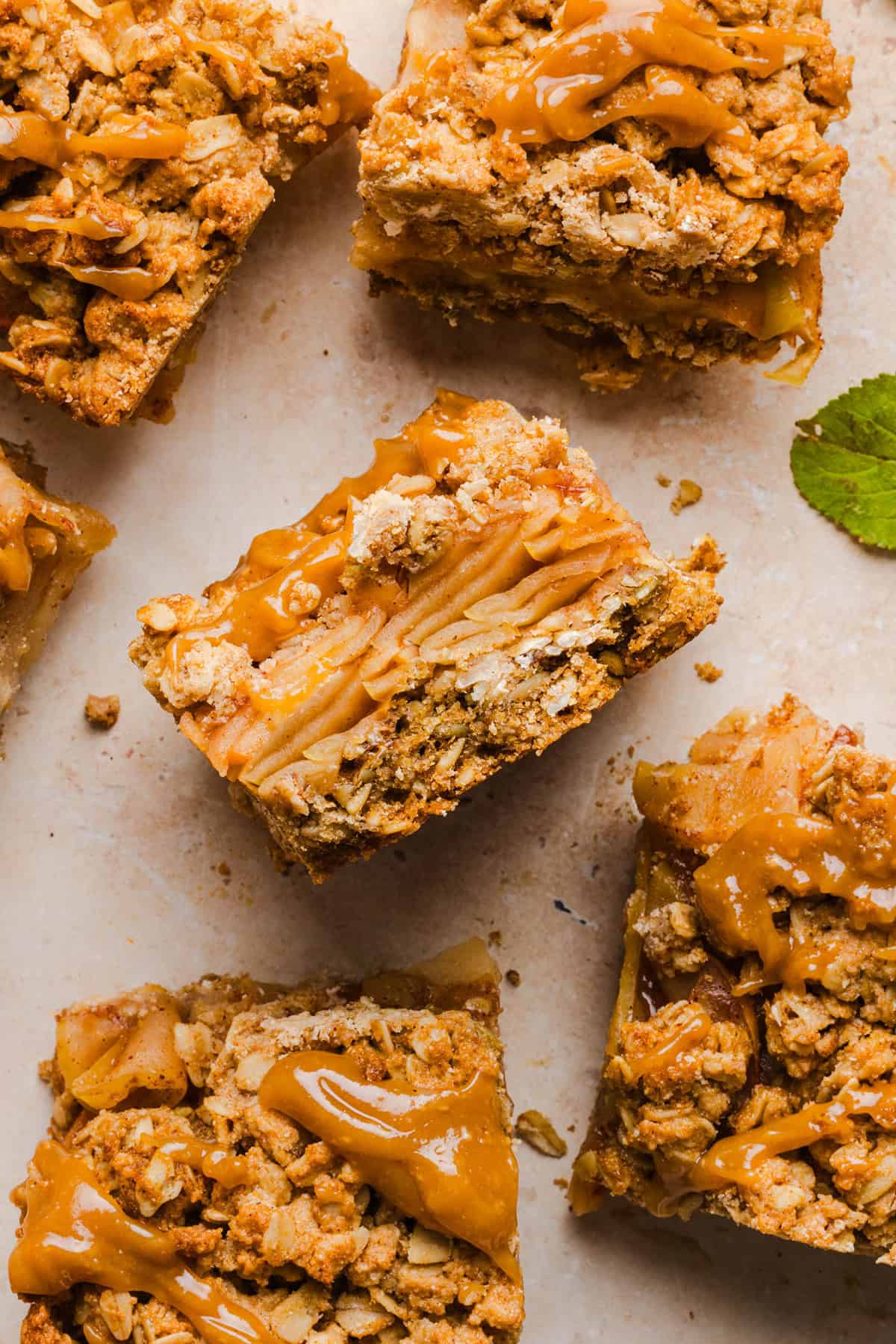 Square apple crumble bars topped with a caramel drizzle, perfect for healthy Thanksgiving desserts.