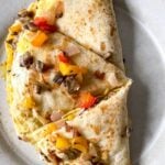 breakfast quesadilla cut into wedges on a plate
