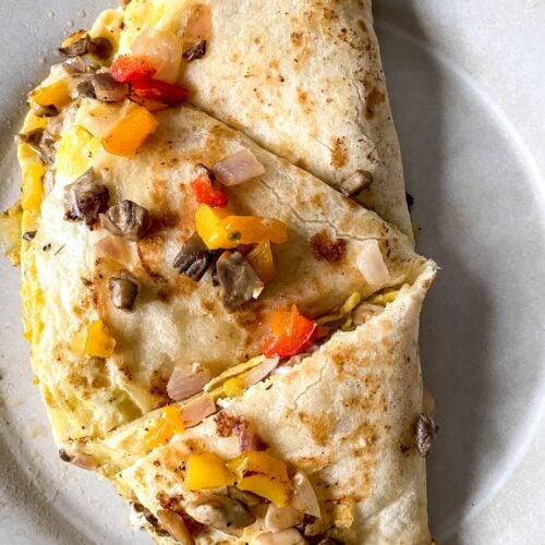 breakfast quesadilla cut into wedges on a plate
