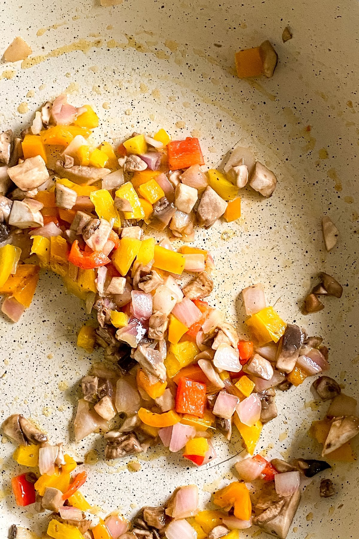 cooked vegetables in a skillet for a breakfast quesadilla
