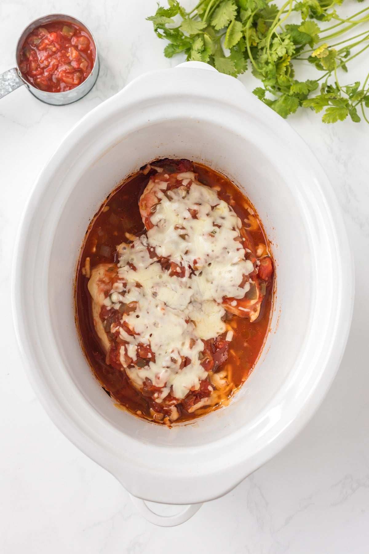 melted cheese on slow cooker salsa chicken