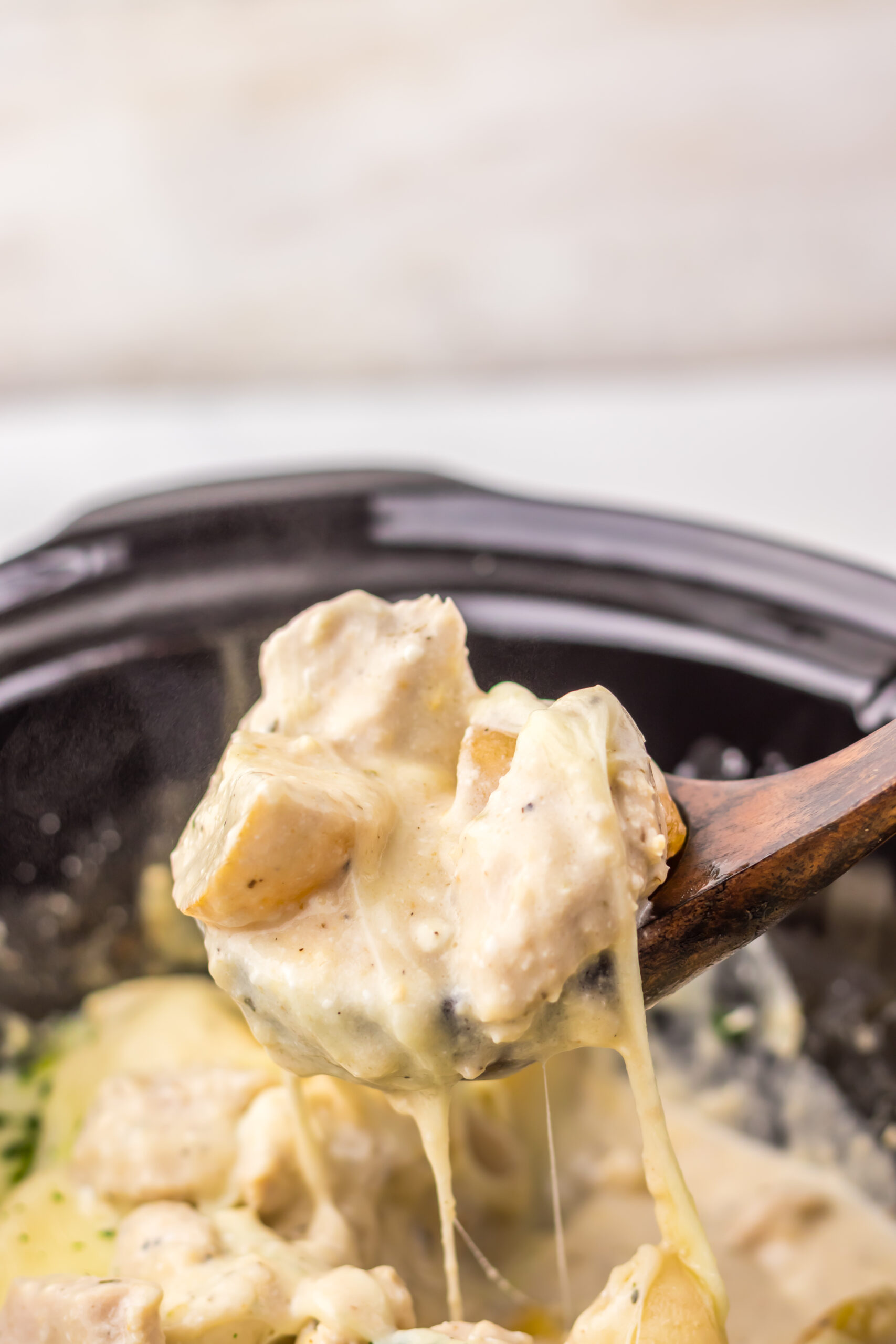 Serving cheesy Caesar chicken and potatoes with a cheese pull.