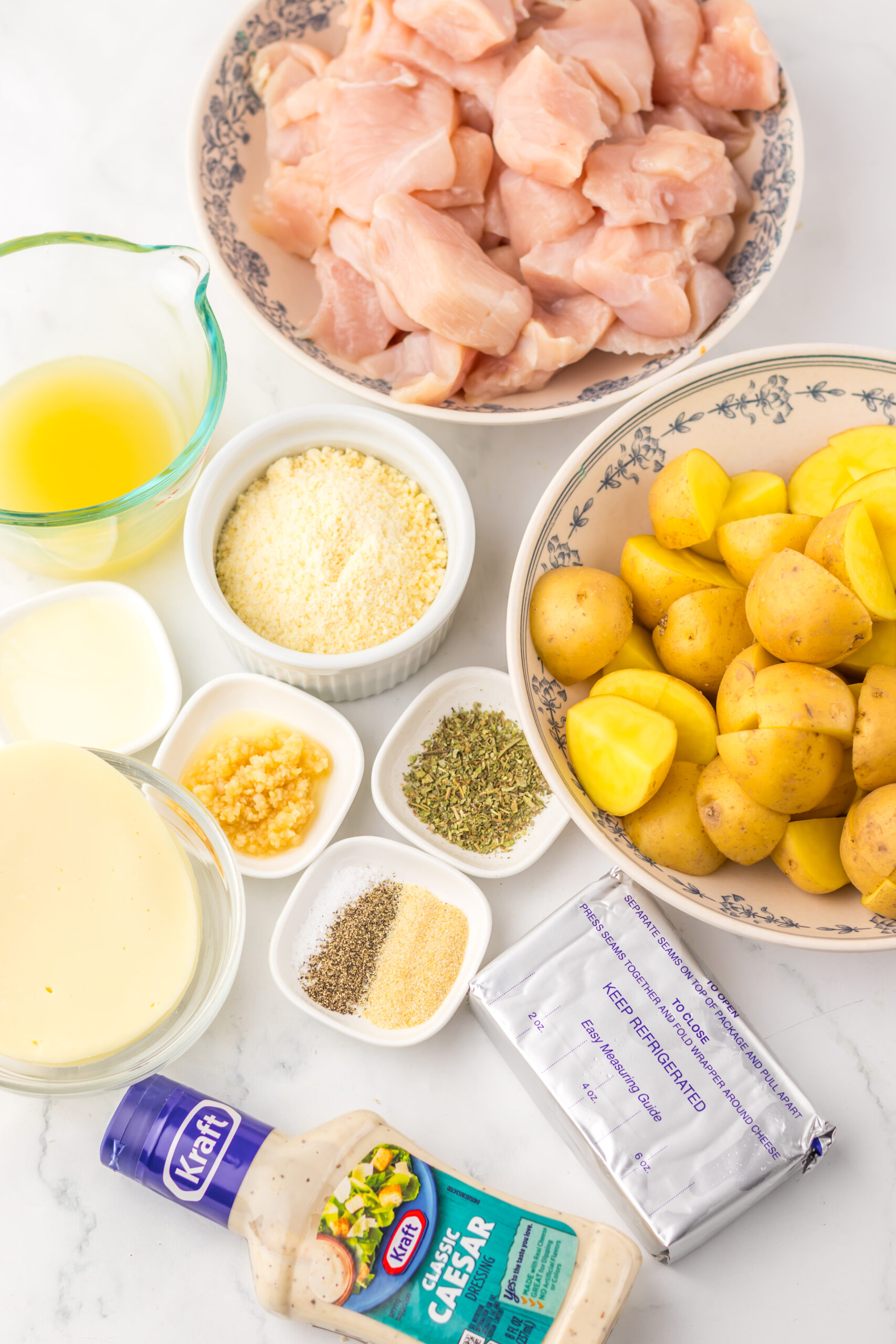 Ingredients for slow cooker cheesy Caesar chicken and potatoes.