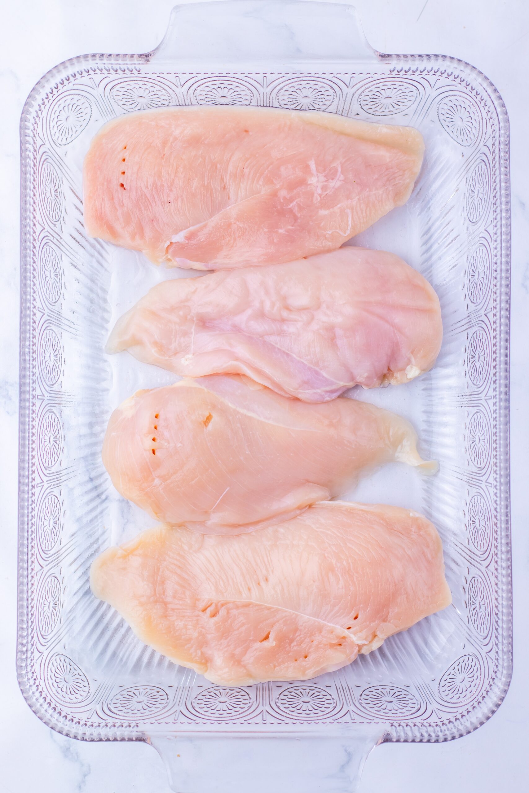 Arrange the chicken in a greased baking dish.