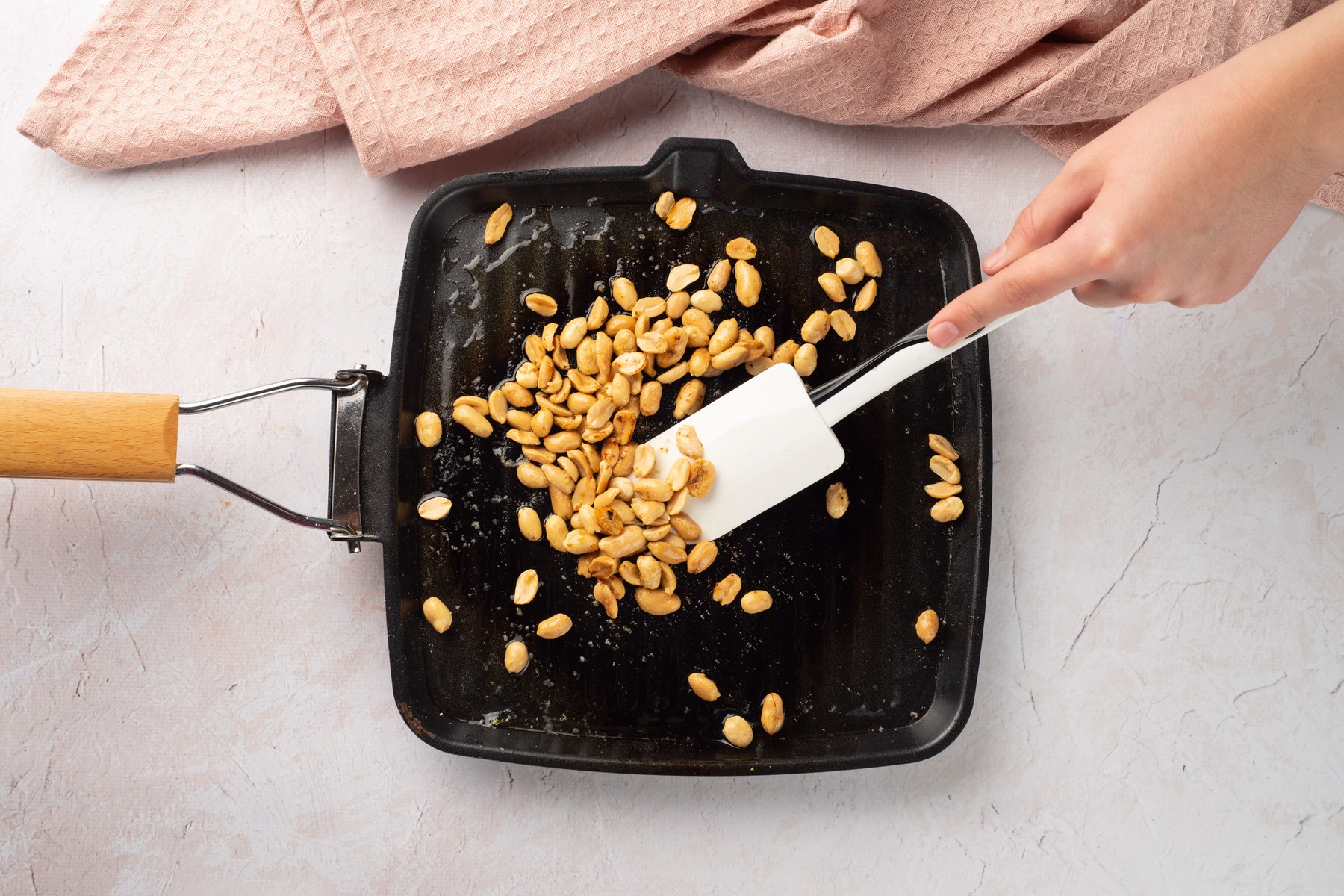 Peanuts toasting in a skillet.