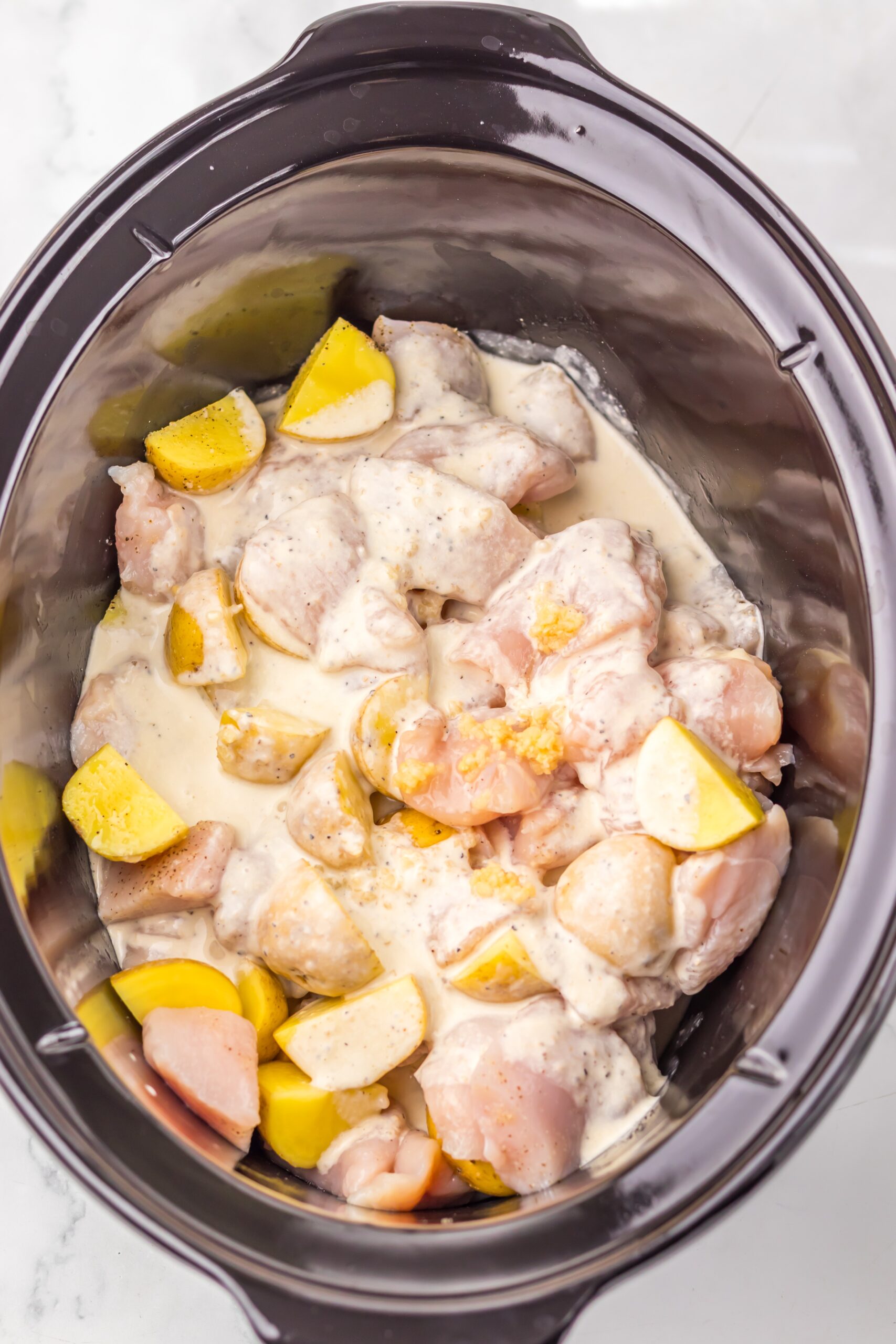 Caesar dressing and broth poured over the chicken and potatoes.