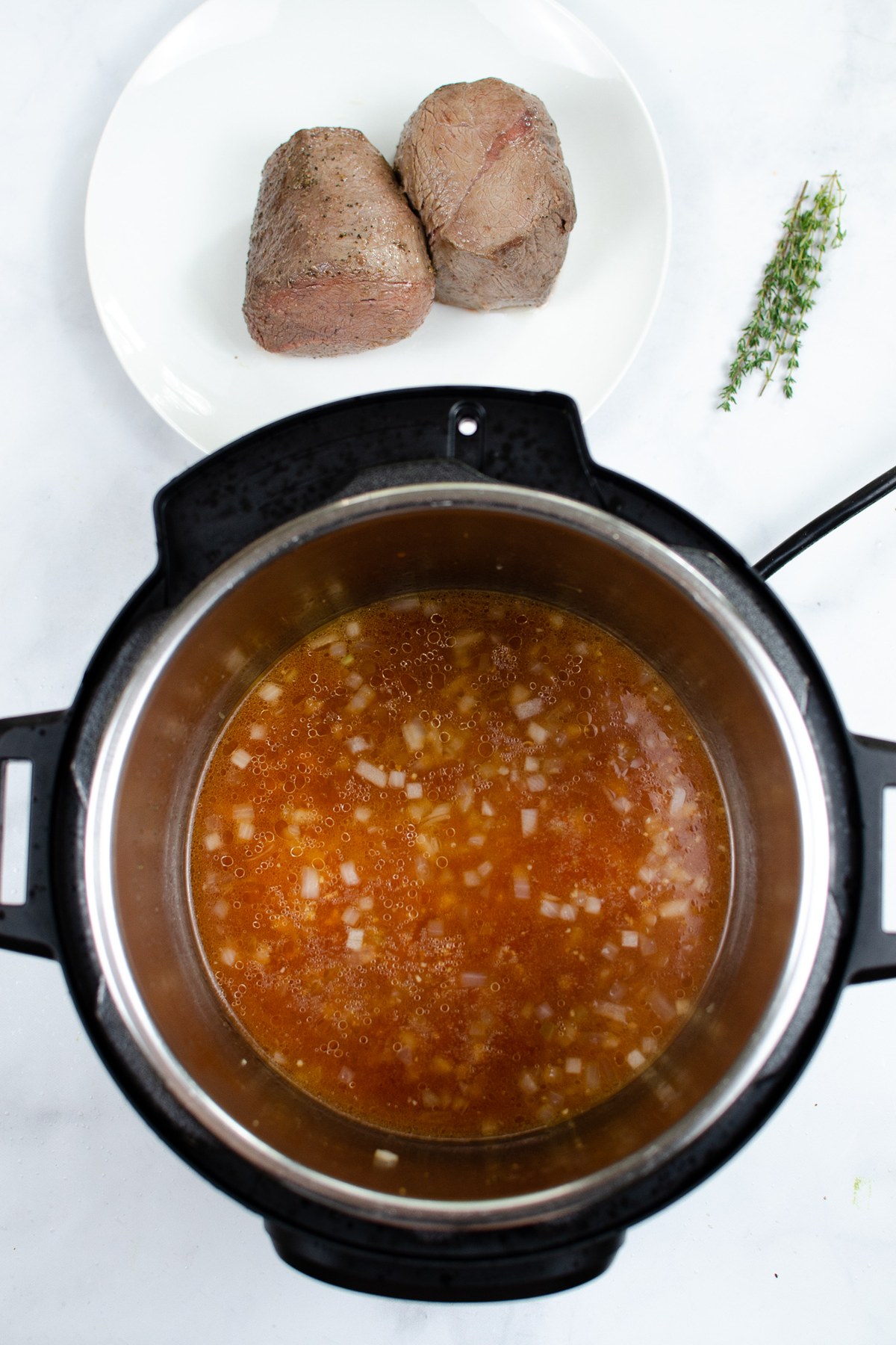 Cook the onion and garlic, then stir in the broth, tomato paste, and Worcestershire.