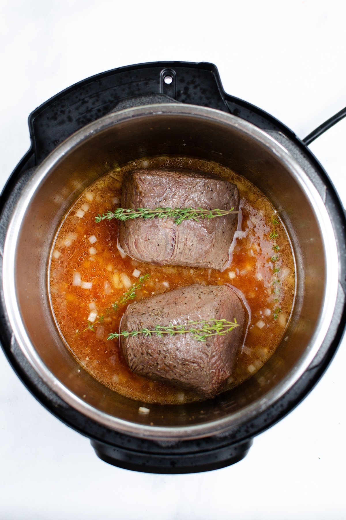 Set the roast back in the pot, top with thyme, and pressure cook for 1 hour.