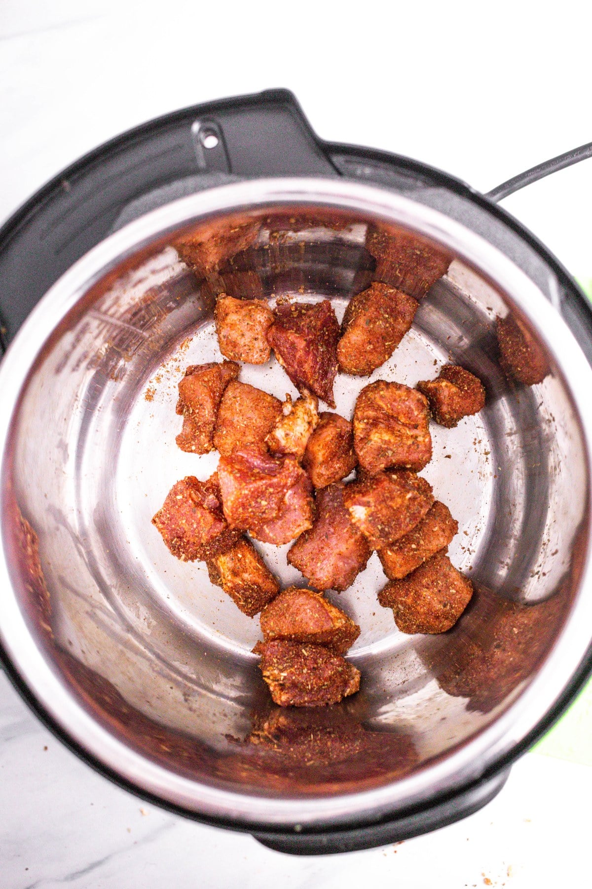 Put the seasoned pork in the Instant Pot.