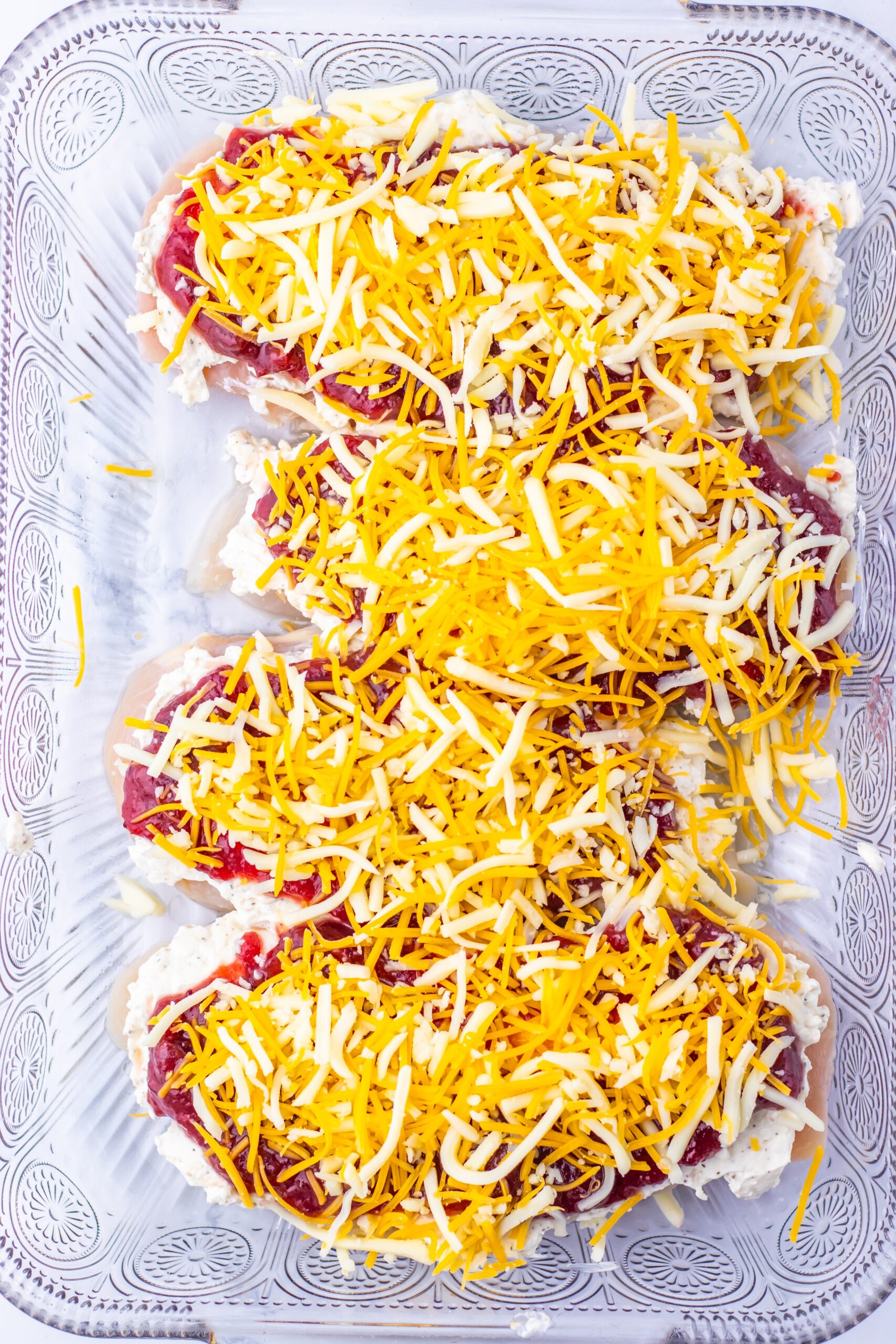 Sprinkle the mozzarella and cheddar evenly over the top.