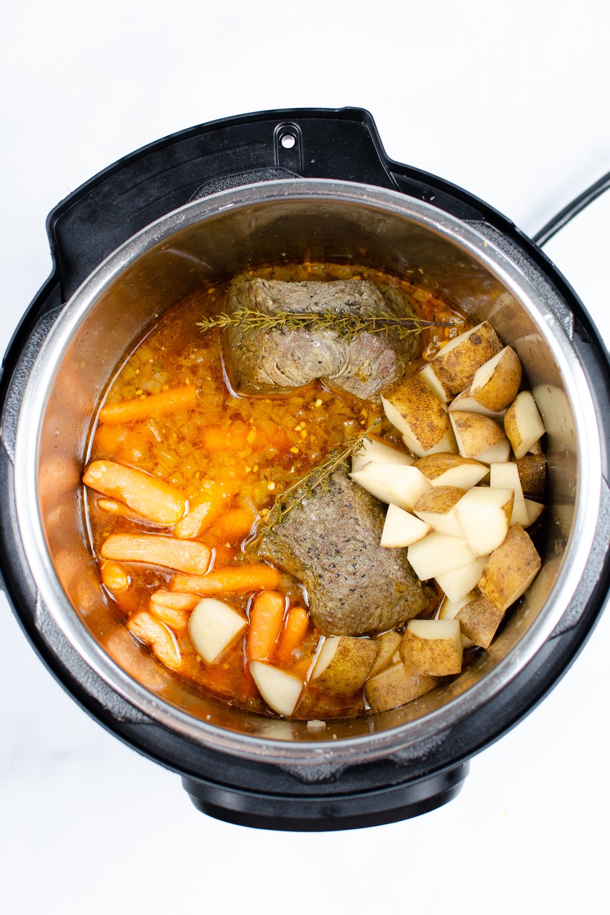 Add the carrots and potatoes and pressure cook for 10 more minutes.
